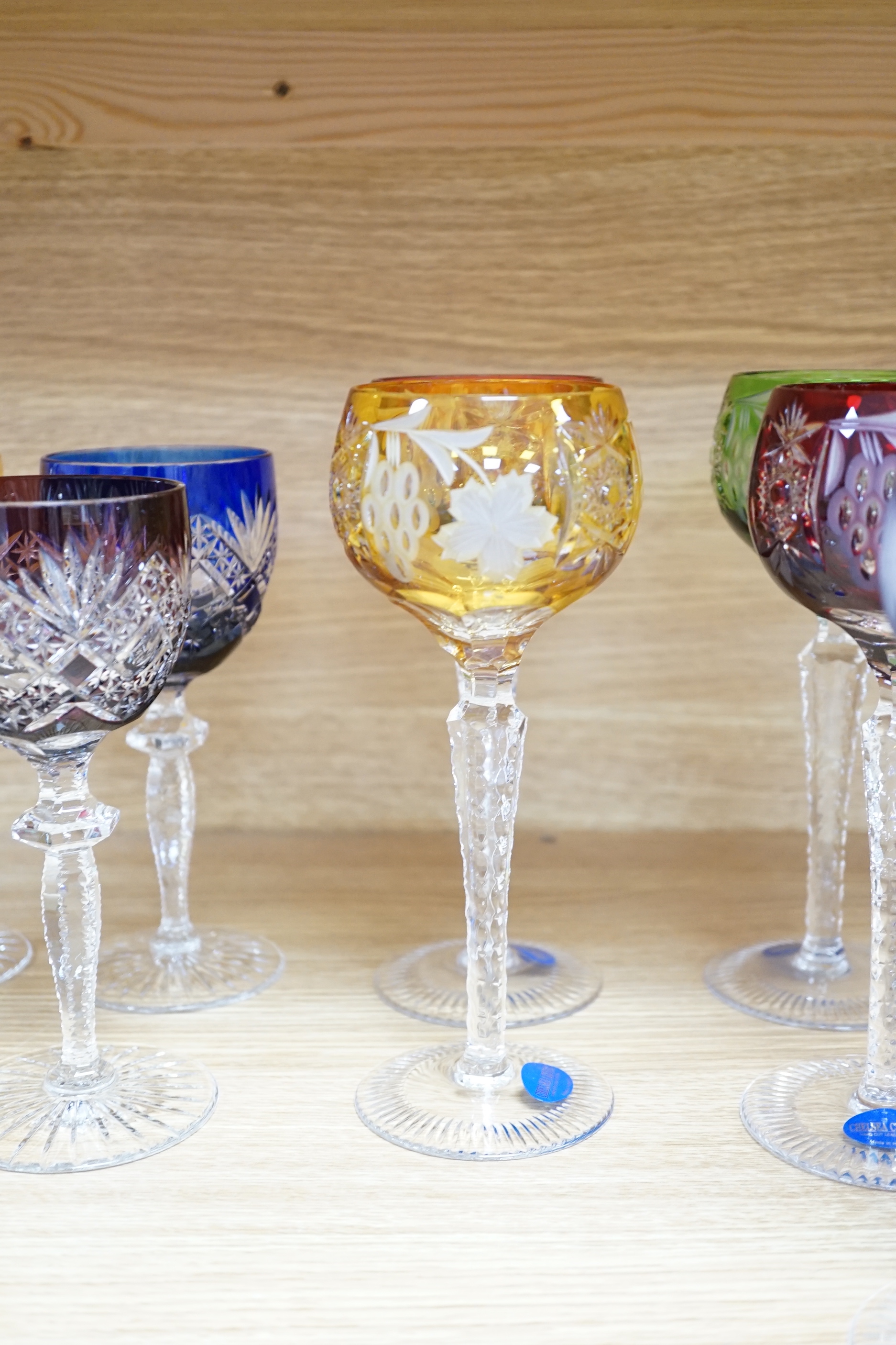 Two sets of six Harlequin colour flashed hock glasses and a set of four air twist glasses